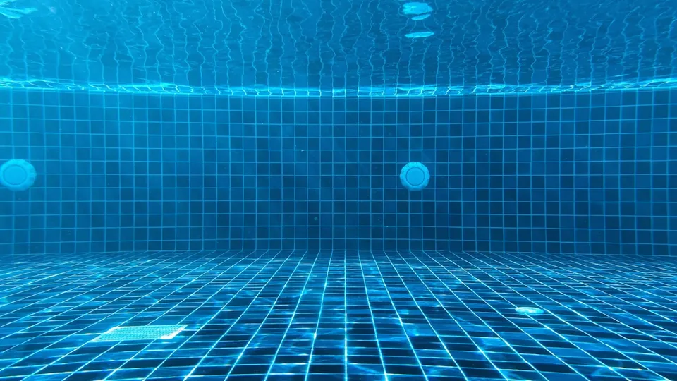 Vue sous-marine d'une piscine aux carreaux bleus